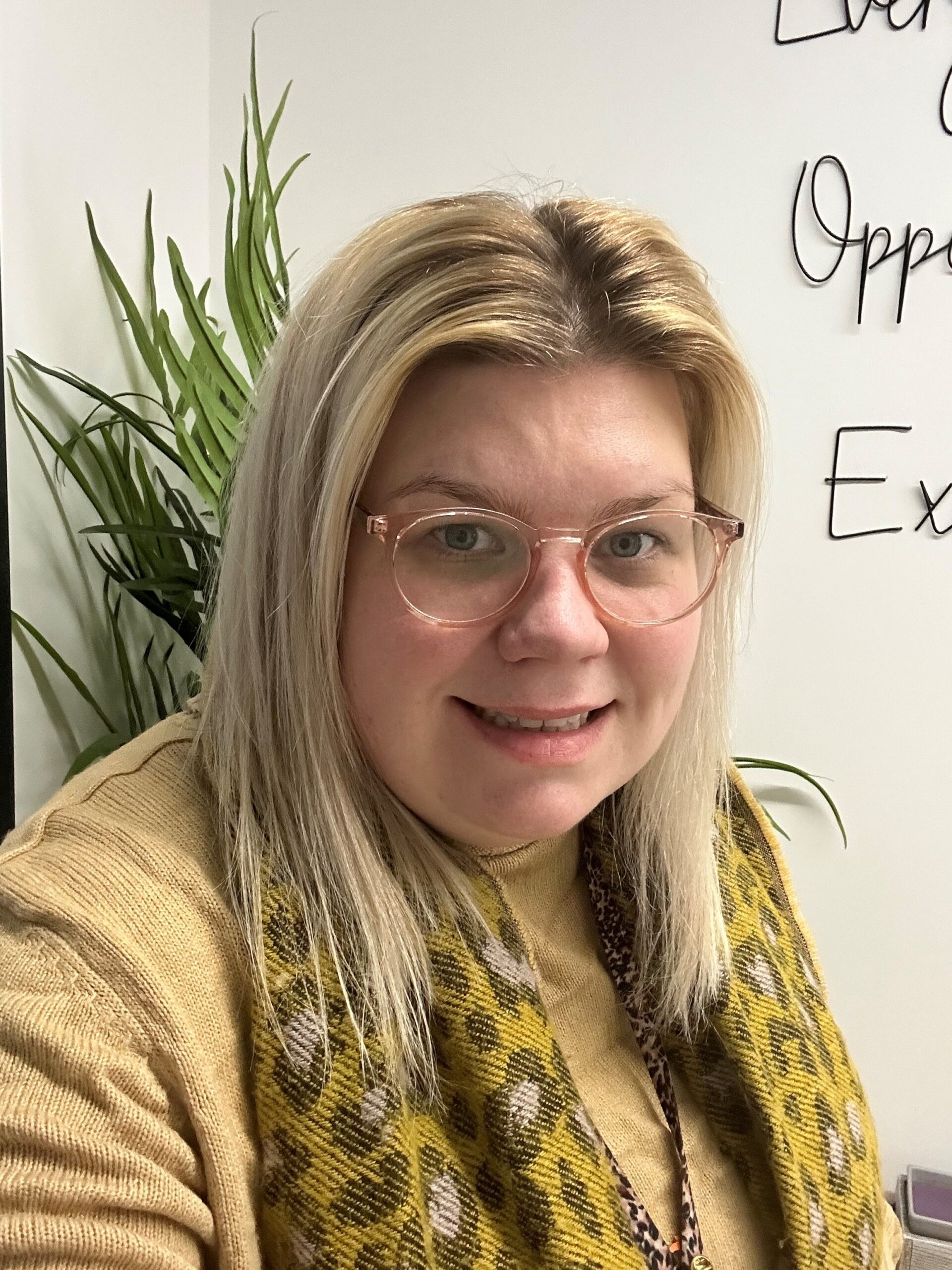 Headshot of olivia Echoes Childcare manager, wearing a yellow top and scarf